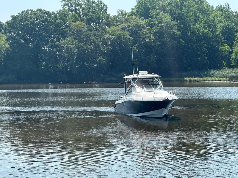Slide: The Image of 2006 Hydra-Sports Vector 2900 VX boat cruising on a calm river with lush greenery. - 7