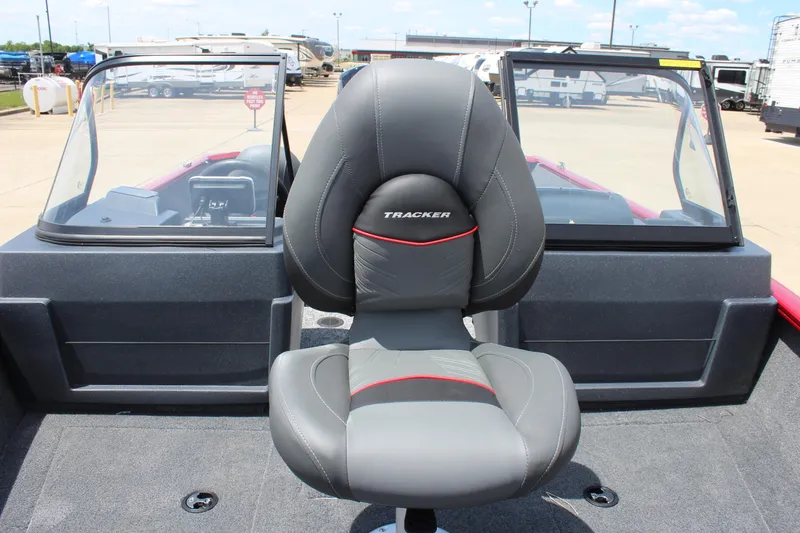 Slide: The Image of 2025 Tracker Pro Guide V-175 Combo boat seat with windshield in a parking lot. - 18