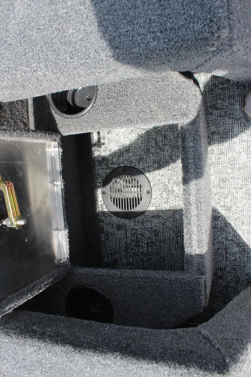 Slide: The Image of Interior view of 2025 Tracker Pro Guide V-175 Combo boat, featuring carpeted flooring and storage compartments. - 25