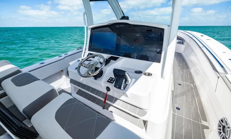 Slide: The Image of 2025 Blackwater 43 Sportfish boat cockpit with modern controls and ocean view. - 15