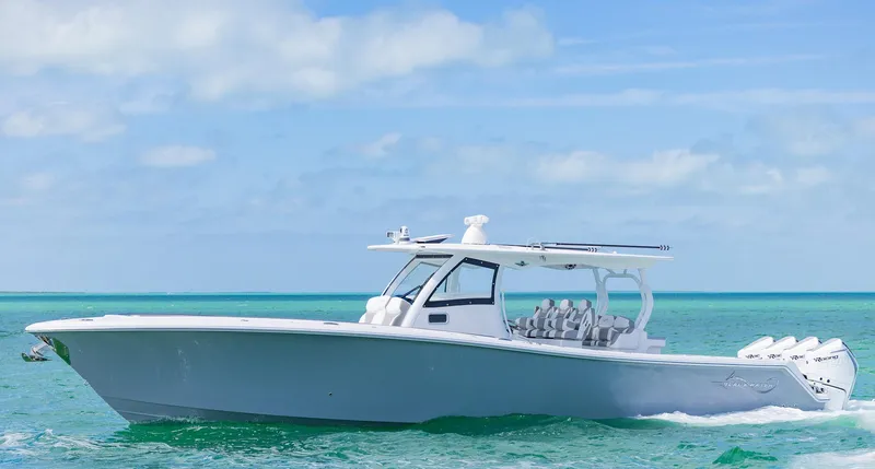 Slide: The Image of 2025 Blackwater 43 Sportfish boat cruising on turquoise ocean waters under a clear sky. - 2