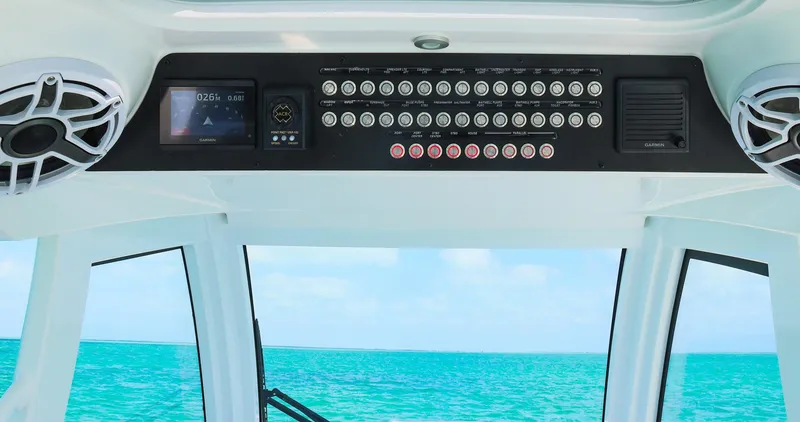 Slide: The Image of 2025 Blackwater 43 Sportfish dashboard with ocean view, featuring advanced controls and speakers. - 26