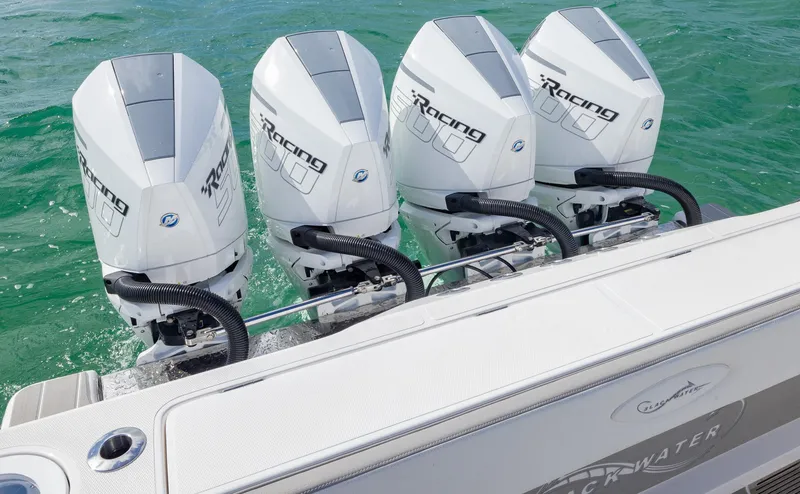 Slide: The Image of Four powerful outboard engines on a 2025 Blackwater 43 Sportfish boat in clear water. - 32