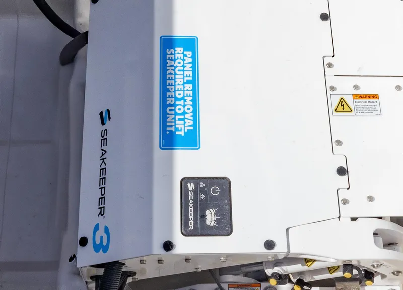 Slide: The Image of Seakeeper 3 unit on 2025 Blackwater 43 Sportfish boat, featuring panel removal warning. - 47
