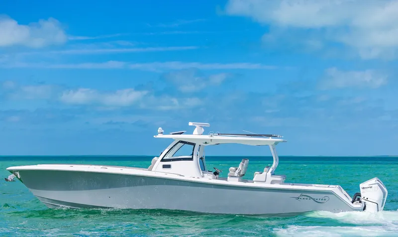 Slide: The Image of 2025 Blackwater 43 Sportfish boat cruising on clear blue ocean waters. - 49