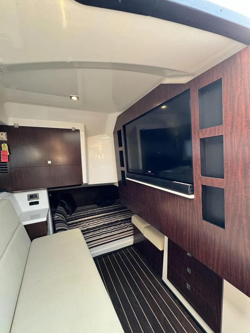 Slide: The Image of Interior of 2018 Monterey 378 Super Express yacht with TV and seating area. - 24