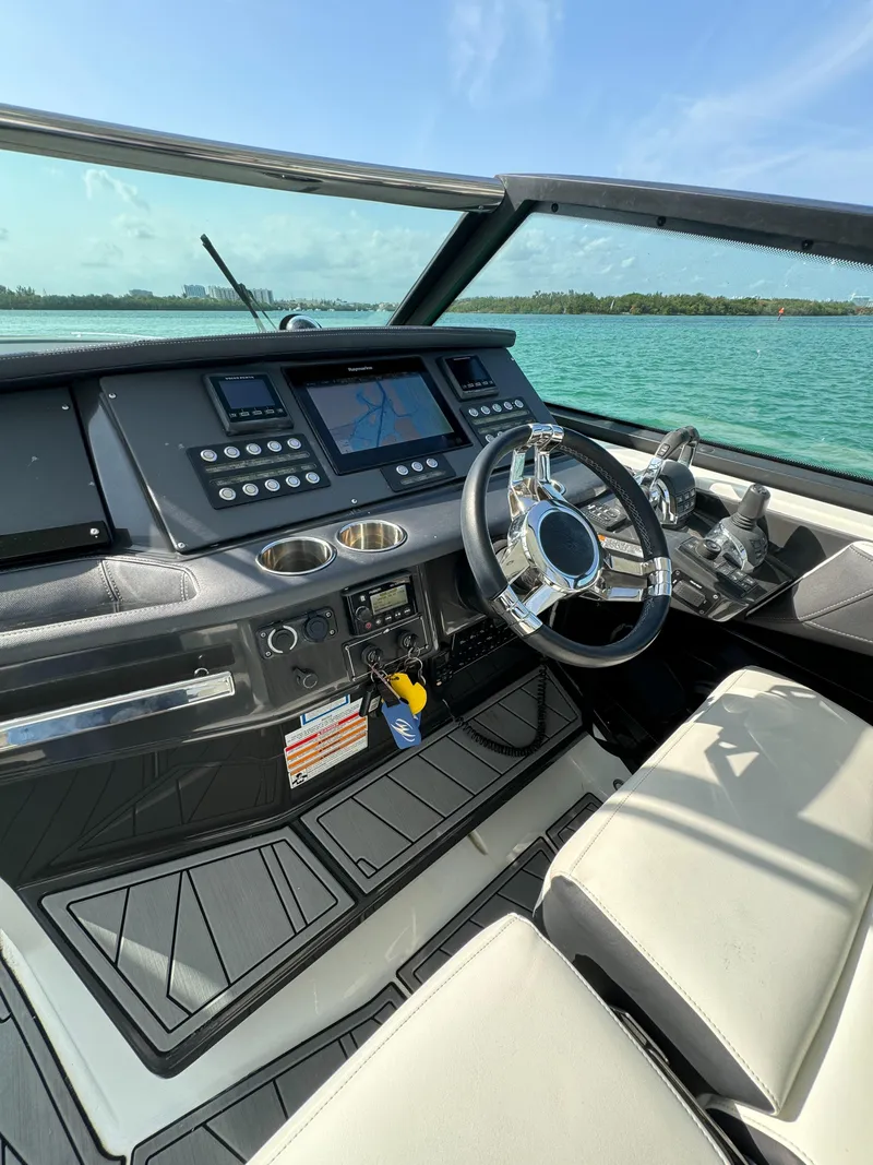 Slide: The Image of 2018 Monterey 378 Super Express boat cockpit with modern controls and steering wheel. - 14