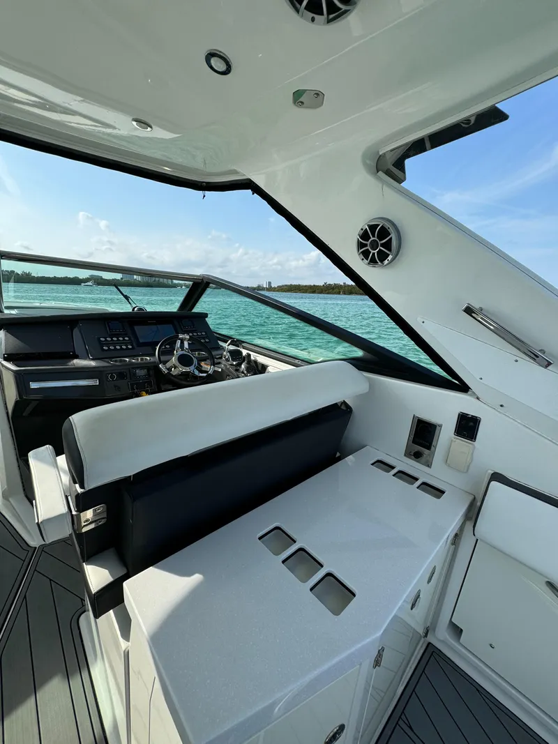 Slide: The Image of 2018 Monterey 378 Super Express yacht interior with helm, seating, and ocean view. - 18