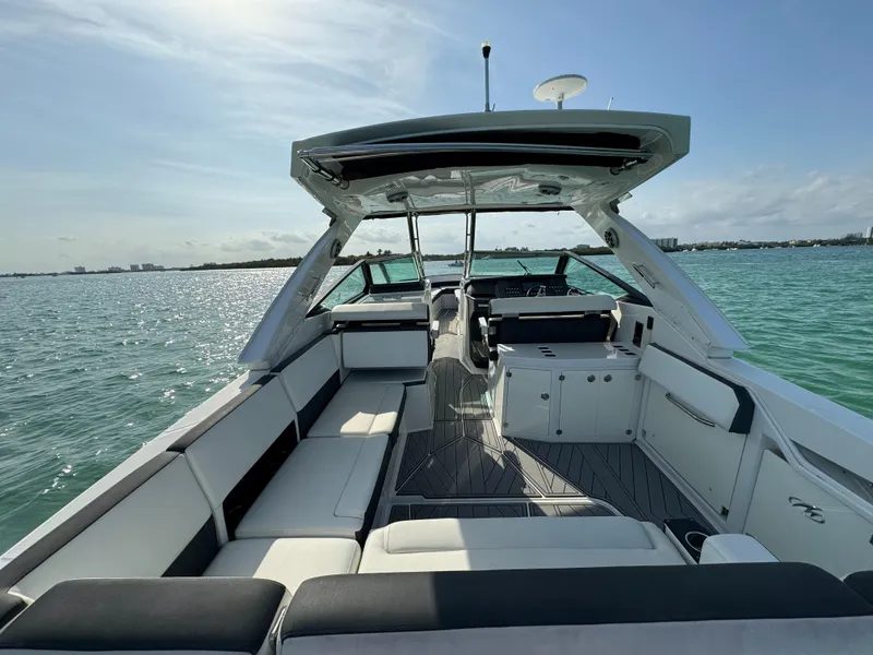 Slide: The Image of 2018 Monterey 378 Super Express boat interior with spacious seating on calm water. - 19