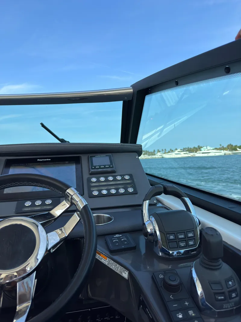 Slide: The Image of Cockpit view of 2018 Monterey 378 Super Express boat with steering wheel and controls. - 21