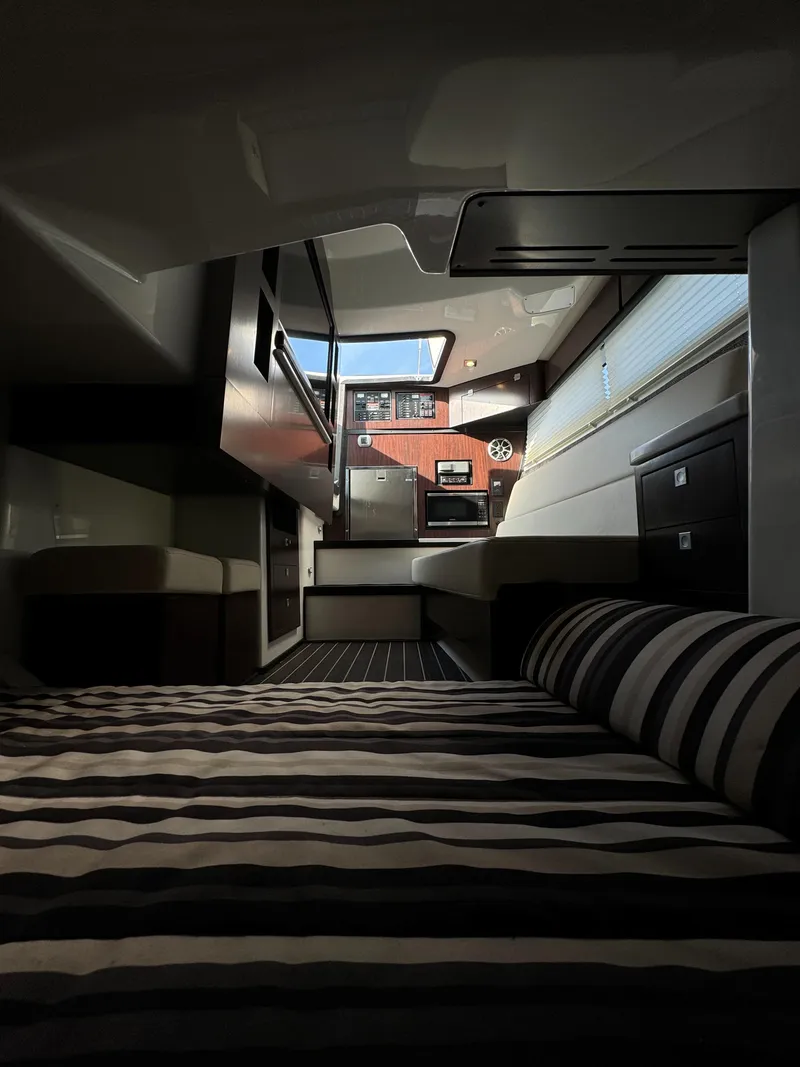 Slide: The Image of Luxurious interior of 2018 Monterey 378 Super Express yacht with striped bedding and modern design. - 23