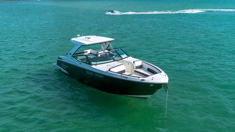 Slide: The Image of 2018 Monterey 378 Super Express boat anchored on clear blue water. - 3