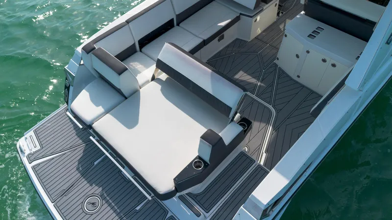 Slide: The Image of 2018 Monterey 378 Super Express boat interior with luxurious seating and sleek design on water. - 5