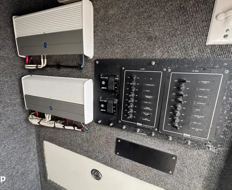 Slide: The Image of JL Audio speaker on 2007 Buddy Davis 31 Custom boat, mounted on wooden deck. - 13