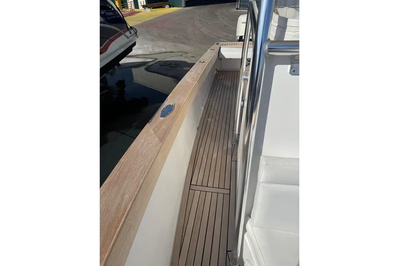 Slide: The Image of 2007 Buddy Davis 31 Custom boat deck with wooden flooring and sleek railing. - 22