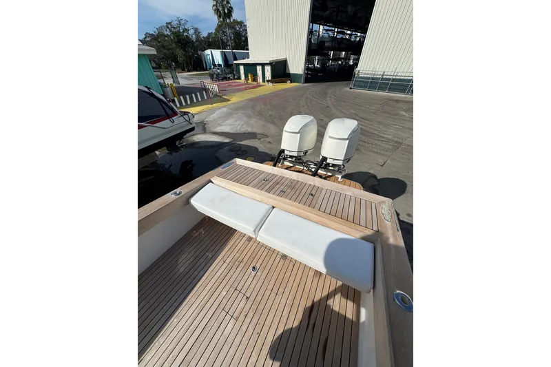 Slide: The Image of 2007 Buddy Davis 31 Custom boat with dual outboard motors on wooden deck. - 23