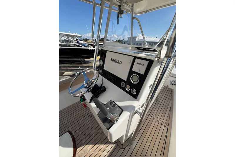 Slide: The Image of 2007 Buddy Davis 31 Custom boat helm with Simrad electronics and wooden deck. - 26