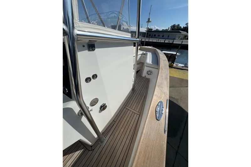 Slide: The Image of 2007 Buddy Davis 31 Custom boat deck with stainless steel railing and wooden flooring. - 27