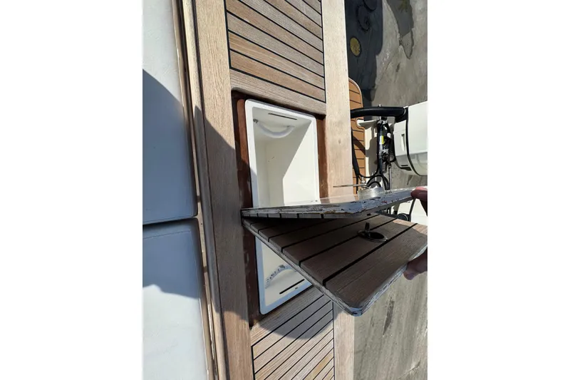 Slide: The Image of Open hatch on 2007 Buddy Davis 31 Custom boat deck, revealing storage compartment. - 28