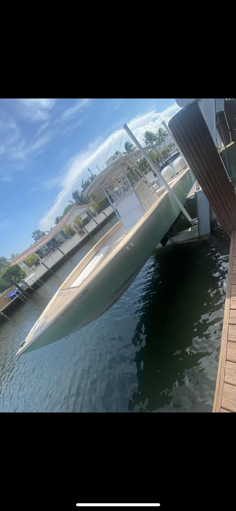 Slide: The Image of Outboard motor of 2007 Buddy Davis 31 Custom boat, docked under clear blue sky. - 3
