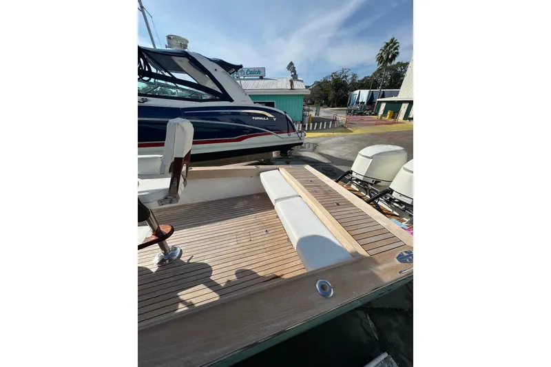 Slide: The Image of 2007 Buddy Davis 31 Custom boat with wooden deck and dual outboard motors. - 31