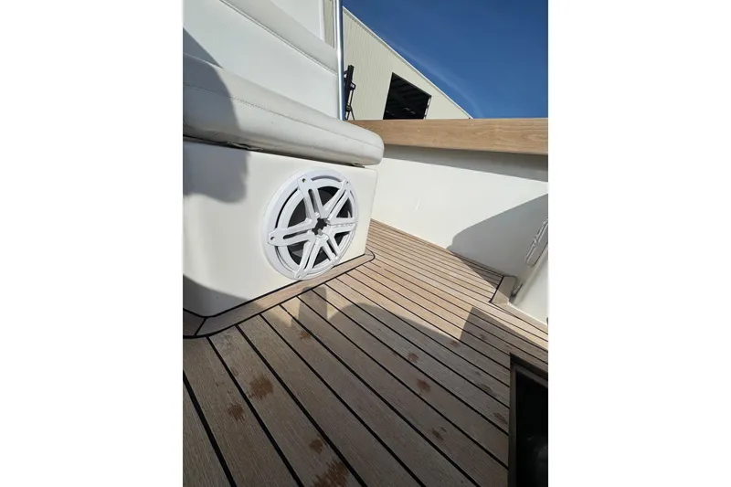 Slide: The Image of 2007 Buddy Davis 31 Custom boat interior with speaker and wooden deck. - 32