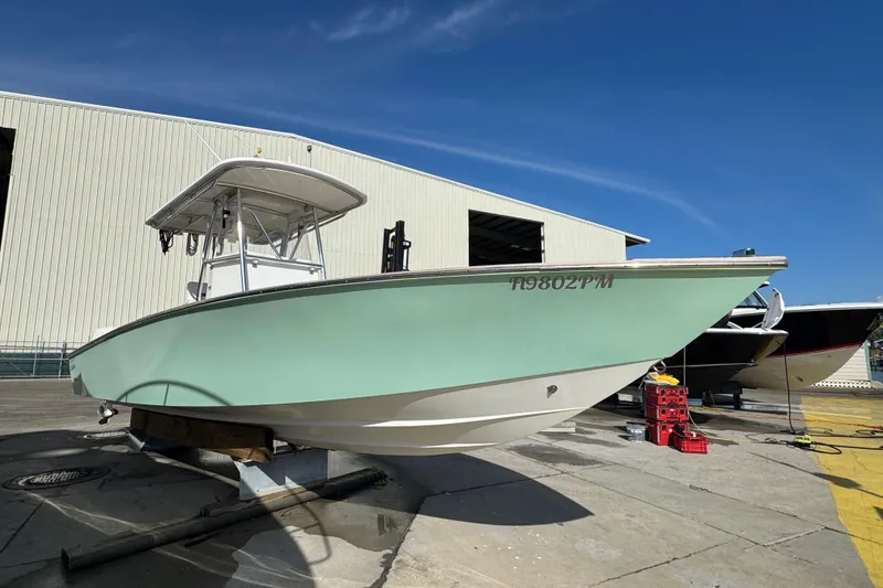 Slide: The Image of 2007 Buddy Davis 31 Custom boat on dry dock, light green hull, sunny day. - 35