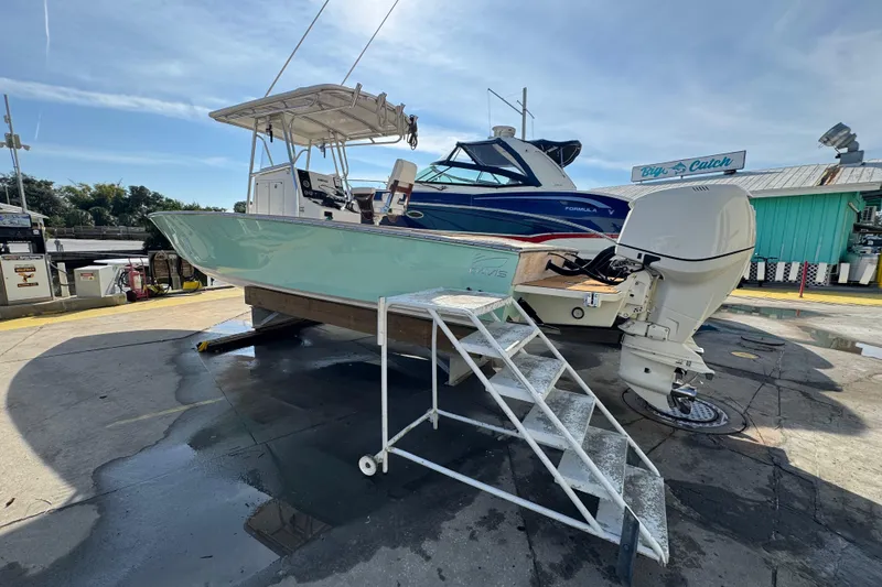 Slide: The Image of 2007 Buddy Davis 31 Custom boat on dry dock with ladder access, marina background. - 37