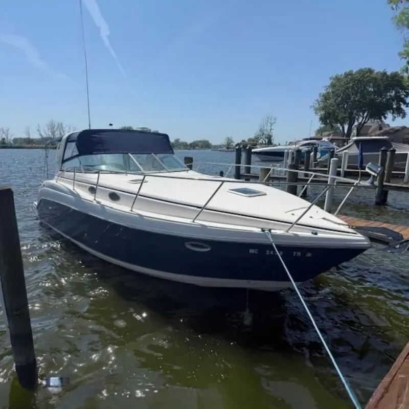 The Image of 2003 Rinker Fiesta Vee 342 boat docked on a sunny day. - 0