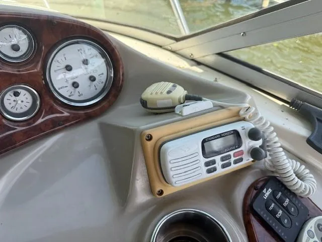 Slide: The Image of Control panel of a 2003 Rinker Fiesta Vee 342 boat with gauges and radio. - 11