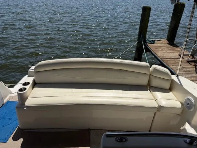 Slide: The Image of 2003 Rinker Fiesta Vee 342 boat with beige seating, docked by the water. - 4