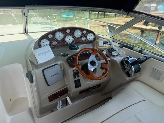 Slide: The Image of 2003 Rinker Fiesta Vee 342 boat dashboard with gauges, steering wheel, and navigation equipment. - 7