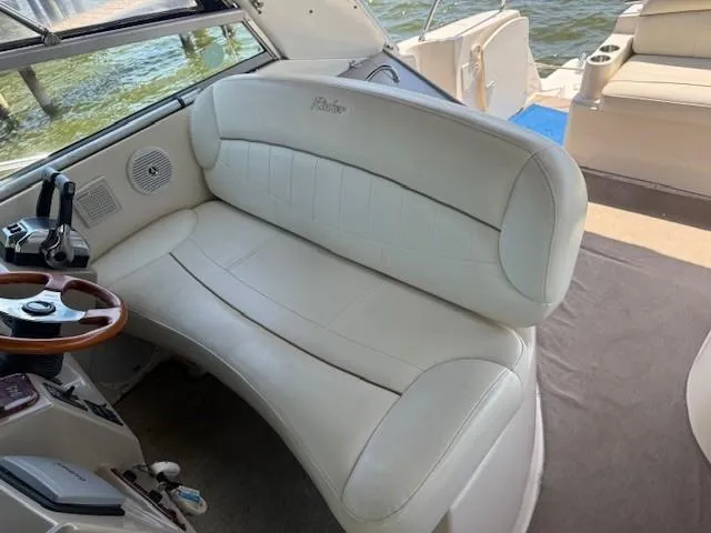 Slide: The Image of 2003 Rinker Fiesta Vee 342 boat interior with white seating and steering wheel. - 8