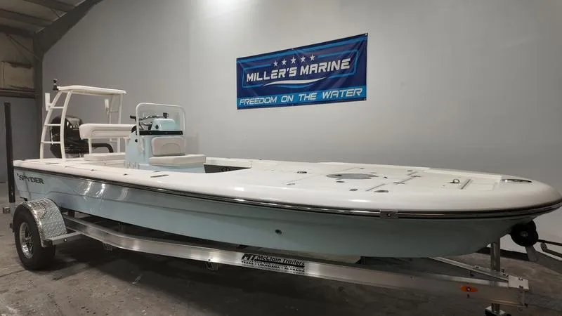 Slide: The Image of 2025 Spyder FX19 Vapor boat on trailer at Miller's Marine showroom. - 2