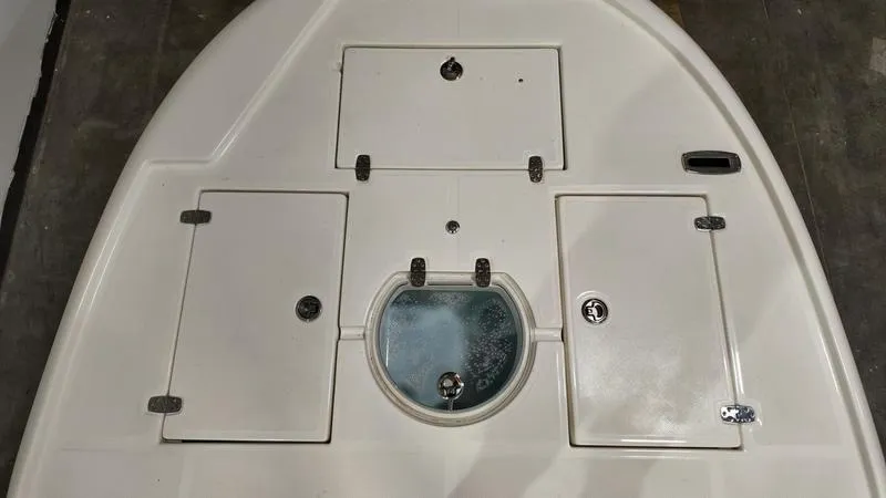 Slide: The Image of 2025 Spyder FX19 Vapor boat deck with storage compartments and circular hatch. - 25