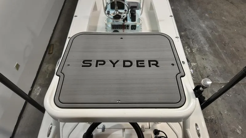 Slide: The Image of 2025 Spyder FX19 Vapor boat deck with steering console in a showroom. - 4