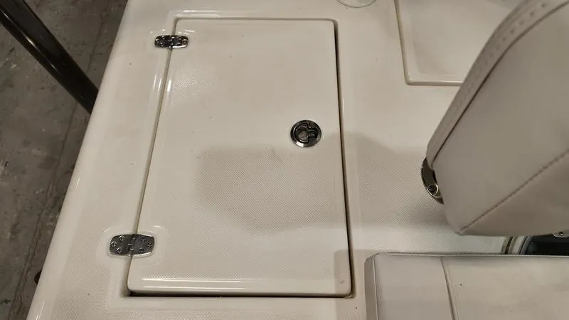 Slide: The Image of Hatch cover on 2025 Spyder FX19 Vapor boat deck with metal hinges and latch. - 9