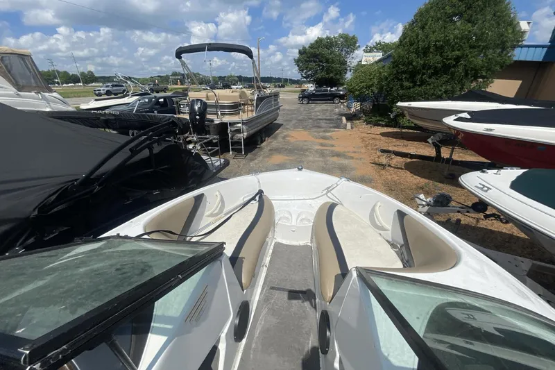 Slide: The Image of 2005 Sea-Doo Utopia 185 boat with open seating, parked outdoors under a sunny sky. - 11