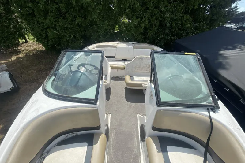 Slide: The Image of 2005 Sea-Doo Utopia 185 boat interior with seating and steering wheel. - 12