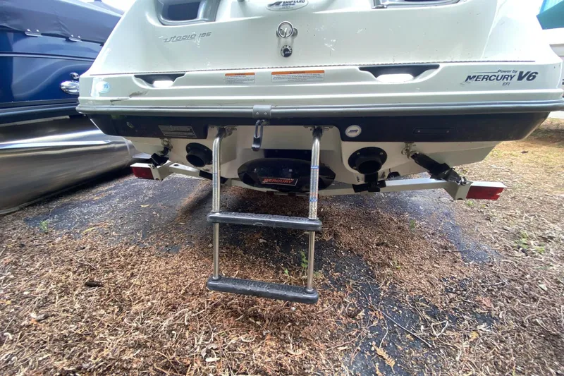 Slide: The Image of 2005 Sea-Doo Utopia 185 boat rear view with ladder and Mercury V6 engine. - 19
