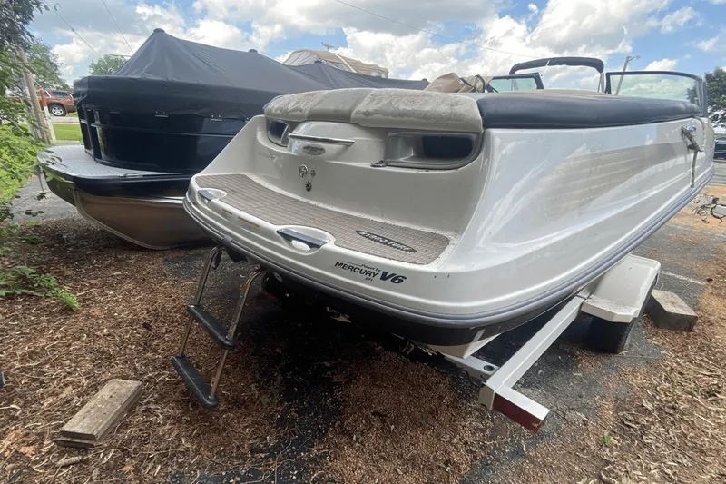 Slide: The Image of 2005 Sea-Doo Utopia 185 boat with Mercury V6 engine, parked on a trailer. - 2