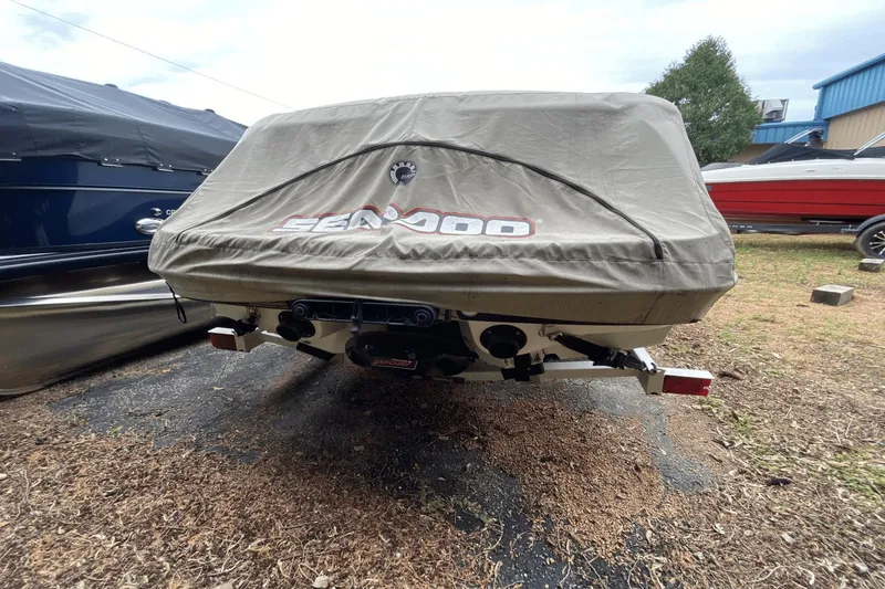 Slide: The Image of 2005 Sea-Doo Utopia 185 boat covered, parked outdoors on a trailer. - 25