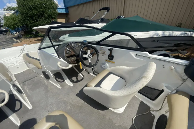 Slide: The Image of 2005 Sea-Doo Utopia 185 boat interior with steering wheel and seating. - 5