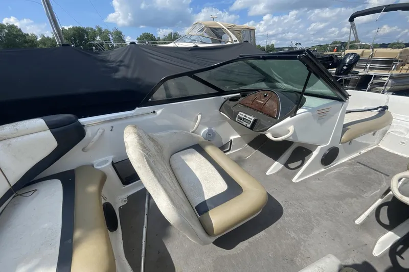 Slide: The Image of 2005 Sea-Doo Utopia 185 boat interior with beige and white seating, steering console, and dashboard. - 8