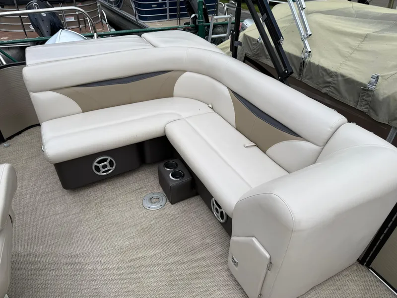 Slide: The Image of Luxurious seating on a 2017 Sweetwater 22 pontoon boat with beige upholstery and cup holders. - 11