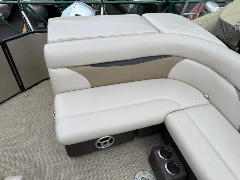 Slide: The Image of Luxurious seating on a 2017 Sweetwater 22 pontoon boat with cup holders and speaker. - 16