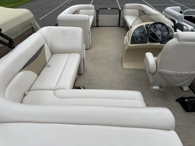 Slide: The Image of Interior of a 2017 Sweetwater 22 pontoon boat with plush seating and steering console. - 19