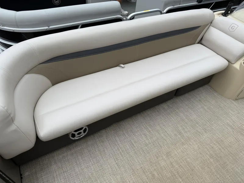 Slide: The Image of Luxurious seating on a 2017 Sweetwater 22 boat, featuring beige upholstery and modern design. - 8