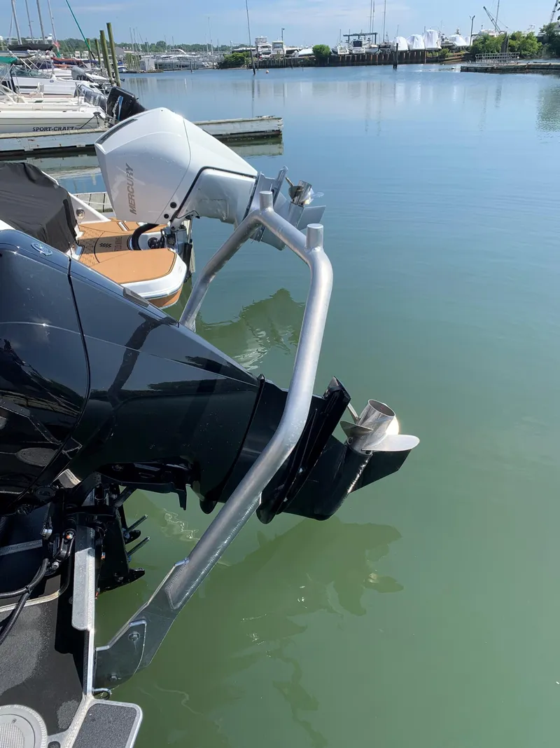 Slide: The Image of Outboard motor on 2023 Life Proof 21 Hard Top boat docked by calm waters. - 6