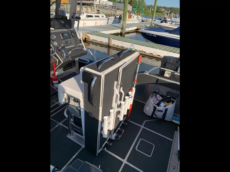 Slide: The Image of 2023 Life Proof 21 Hard Top boat interior with equipment and dock view. - 9